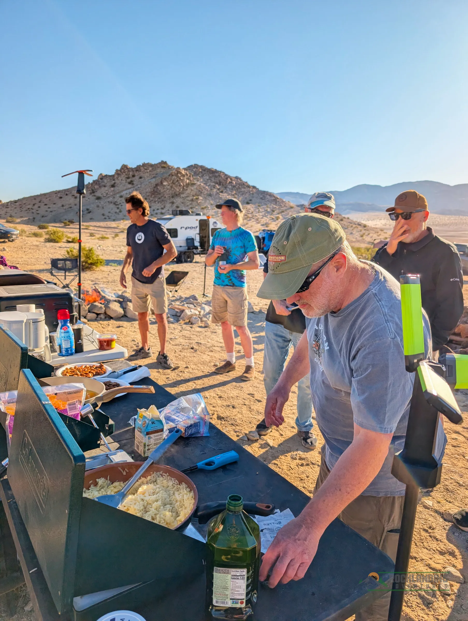 Breakfast burritos on a folding table at desert basecamp.