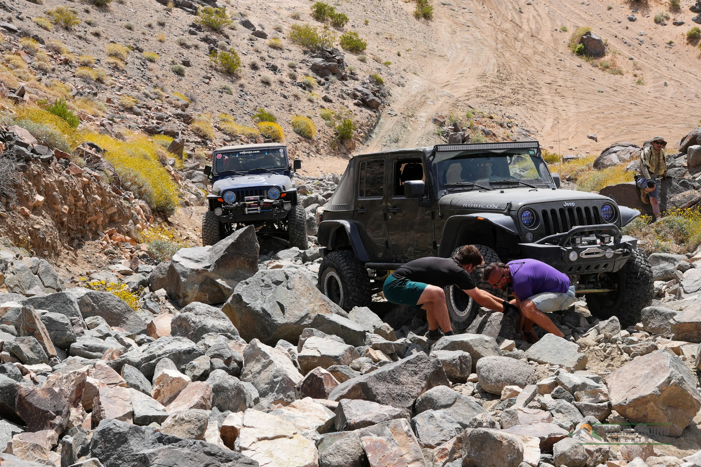 Turning rocks to build a path on a rocky hill.
